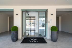 a revolving door in a building with two plants at Almy Luxury Apartments in Chania Town