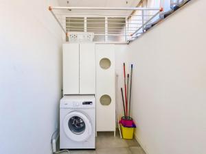 a laundry room with a washer and dryer at FLH Monte Gordo Summer Flat in Monte Gordo