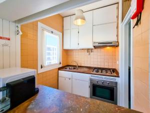 a small kitchen with a sink and a stove at FLH Monte Gordo Summer Flat in Monte Gordo +6 photos