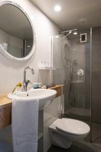 a bathroom with a sink and a toilet and a shower at Maxim Design Hotel 3 Star Superior in Tel Aviv