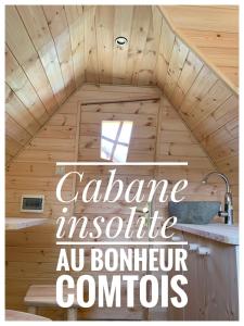 a wooden cabin with a roof with the words cabinane insurance absolute au bombardier at Insolite avec piscine Au Bonheur Comtois in Ronchamp