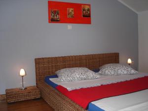 a bed with two pillows on it in a room at Apartments Dalmatina in Zaton +44 photos