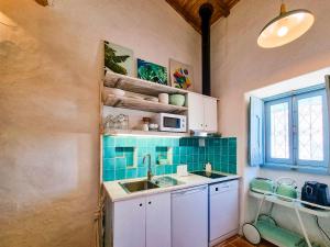 a kitchen with a sink and a microwave at FLH Vale Judeu Rustic Mezzanine Cottage I in Loulé