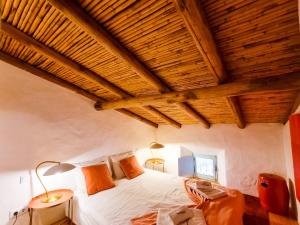 a bedroom with a bed and a wooden ceiling at FLH Vale Judeu Rustic Mezzanine Cottage I in Loulé