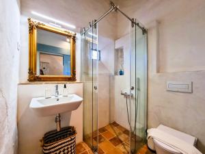 a bathroom with a sink and a glass shower at FLH Vale Judeu Rustic Mezzanine Cottage I in Loulé