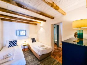 a room with a bed and a couch and a table at FLH Vale Judeu Rustic Mezzanine Cottage I in Loulé