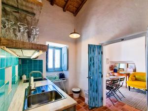 a kitchen with a sink and a counter top at FLH Vale Judeu Rustic Mezzanine Cottage I in Loulé