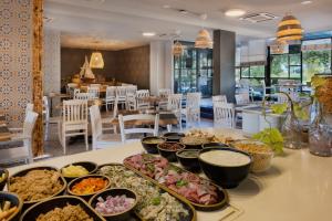 a buffet of food on a table in a restaurant at Play Eilat Hotel in Eilat