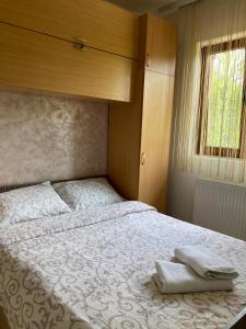 a bedroom with a bed with two towels on it at Kuca za uzivanje in Valjevo