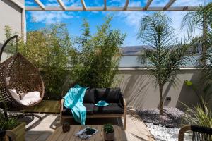 a patio with a hammock and a chair at Delight Luxury Residences - Souda in Souda