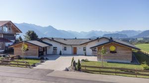 a group of houses with mountains in the background at Die Zwei Sonnen Chalets in Ofterschwang