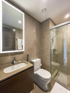 a bathroom with a toilet and a sink and a shower at STAY BY LATINEM Luxury 2BR Holiday Home CV B1309 Near Burj Khalifa in Dubai