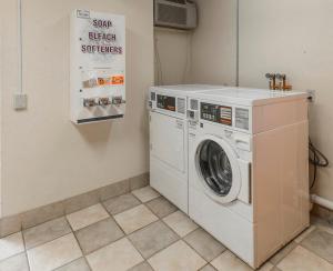 a laundry room with a washer and dryer at Baymont Inn & Suites by Wyndham Lincoln NE in Lincoln