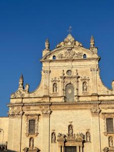 a tall building with a blue sky in the background at Suite San Pietro in Galatina +4 photos