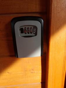 a remote control embedded in a wooden cabinet at Orla Chata Domy in Świnoujście