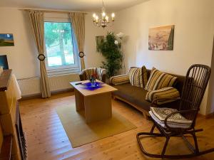 a living room with a couch and a table at Hotel Gutshaus Kajahn in Gustow