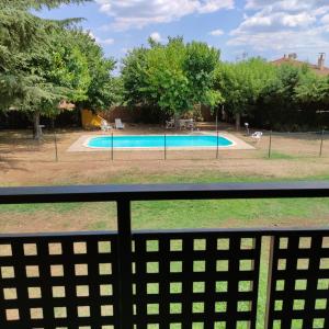 a view of a swimming pool from a fence at Alberg Restaurant Bellavista in Santa Pau