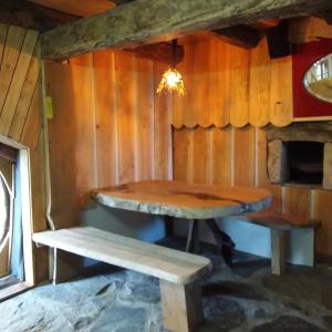 a dining room with a table and a bench at Village.insolite in Montagny-sur-Grosne