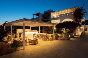 a patio with tables and chairs under a pavilion at KAMEO, Antiparos in Antiparos