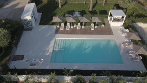 an overhead view of a swimming pool with chairs and a house at La Locanda dei Cavalieri Country House in Civitanova Marche