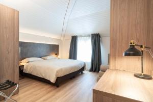 Ein Bett oder Betten in einem Zimmer der Unterkunft Relais Lucomagno