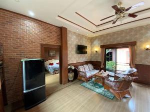 a living room with a couch and a tv at Magadan Residence in Pattaya South