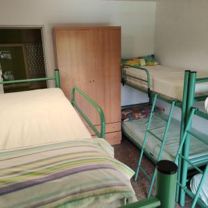a room with two bunk beds and a closet at Alberg Restaurant Bellavista in Santa Pau