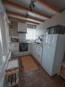 a kitchen with white appliances and a white refrigerator at La Ferme Étoilée in Valençay