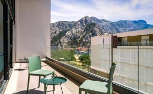 a balcony with chairs and a view of mountains at Rivus Apartments in Omiš