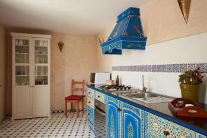 a kitchen with blue and white tiled counters and a sink at Riad Ocean View - Entire Accommodation in Rabat