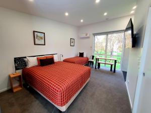 a bedroom with a large bed and a large window at Port Arthur Villas in Port Arthur