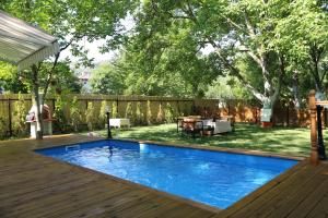 a swimming pool in a backyard with a wooden deck at Ozyo Sapanca Village in Sapanca