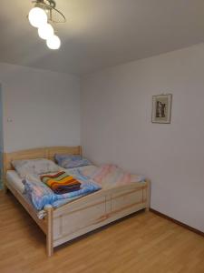 a bedroom with a wooden bed in a room at Pokoje Gościnne Tomasz in Międzywodzie