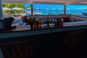 a bar with a bunch of bottles of wine at Orangea Beach Resort in Andilana