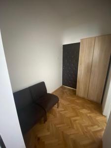 a living room with a couch and a wooden floor at Apartmani Home in Zaječar
