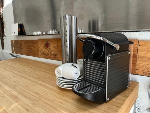 a toaster oven sitting on top of a table at Maison de la Calonne - Riverside house & terrace in Cormeilles