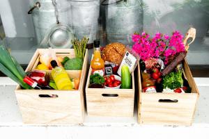 two wooden crates filled with different types of vegetables at Moens Motell in Fiskå
