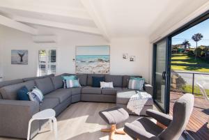 a living room with a couch and chairs at Close to Coast in Forster
