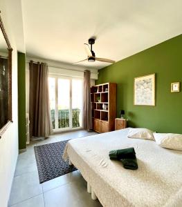 a bedroom with a bed and a green wall at 2 Bedrooms - Sea View Apartment in Nice