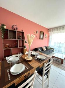 a dining room with a table and a couch at 2 Bedrooms - Sea View Apartment in Nice