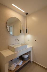 a bathroom with a sink and a mirror at KAMEO, Antiparos in Antiparos