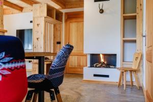 a living room with a table and a fireplace at Villa Capra - Apartments Adult Only in Zakopane