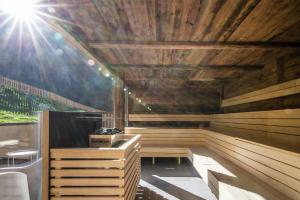 a sauna with wooden walls and a ceiling with at Berghaus Schröcken - Hotel Apartments Spa in Schröcken
