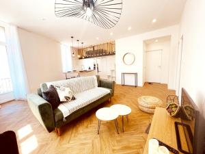 a living room with a couch and a table at Le Jungle SPA **** in Nîmes