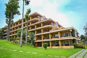 a large yellow building with trees in front of it at The Carlton Kodaikanal in Kodaikānāl