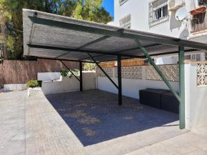 awning on the side of a building at "COZY LOFT", TERRACE, PARKING and SWIMMING POOL in Málaga