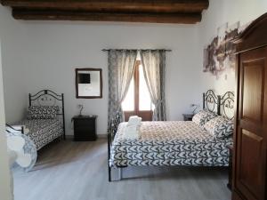 een slaapkamer met 2 bedden en een raam bij Bed And Breakfast Polizzi House in Petralia Sottana