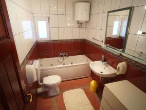 a bathroom with a tub and a toilet and a sink at Sea House Mljet in Polače