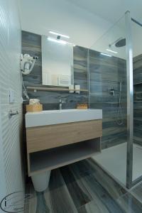 a bathroom with a sink and a mirror at I Bordin Home in Nettuno