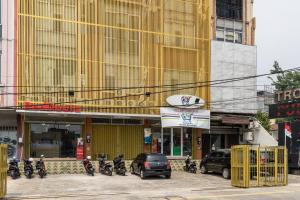 a group of motorcycles parked in front of a building at RedDoorz Plus Near RS Royal Taruma Grogol in Jakarta